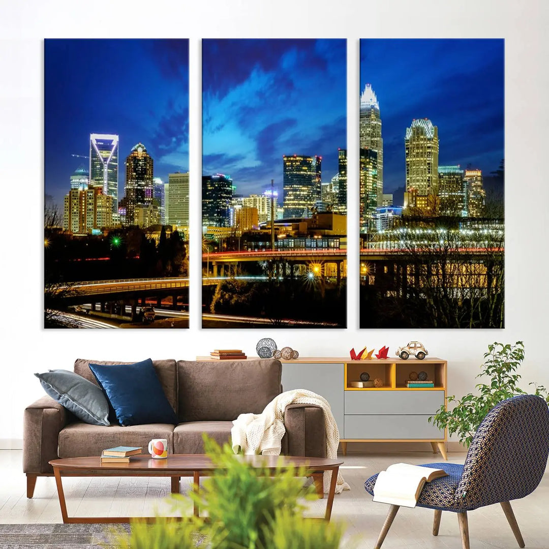 A modern living room highlighted by the "Charlotte City Lights Cloudy Blue Night Skyline Cityscape View" wall art canvas print, crafted on museum-quality canvas with UV-protective coating.