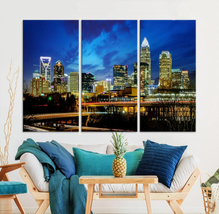 A modern living room highlighted by the "Charlotte City Lights Cloudy Blue Night Skyline Cityscape View" wall art canvas print, crafted on museum-quality canvas with UV-protective coating.