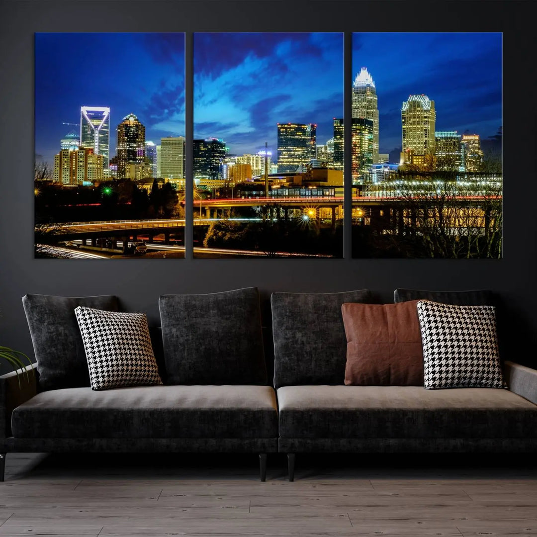 A modern living room highlighted by the "Charlotte City Lights Cloudy Blue Night Skyline Cityscape View" wall art canvas print, crafted on museum-quality canvas with UV-protective coating.