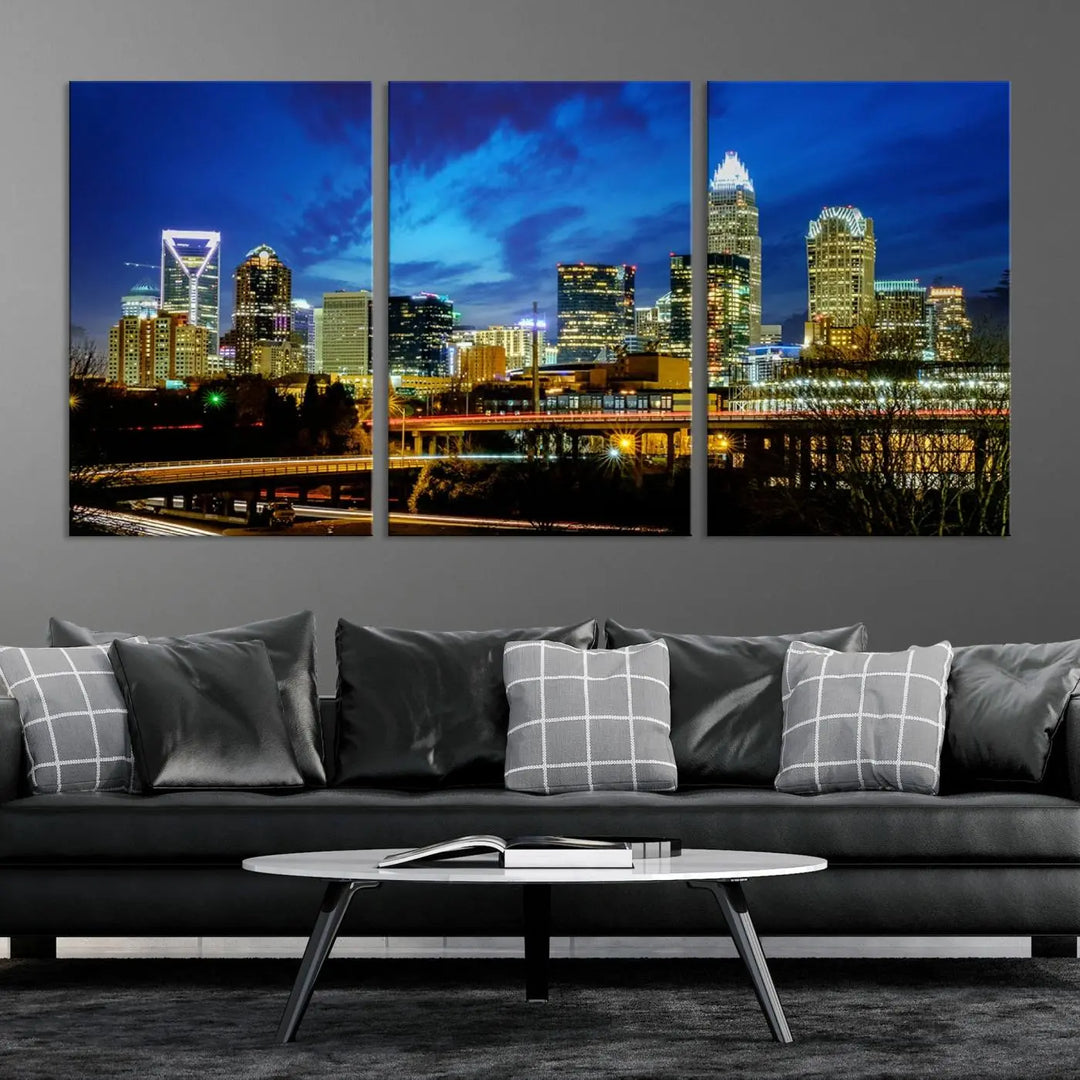 A modern living room highlighted by the "Charlotte City Lights Cloudy Blue Night Skyline Cityscape View" wall art canvas print, crafted on museum-quality canvas with UV-protective coating.