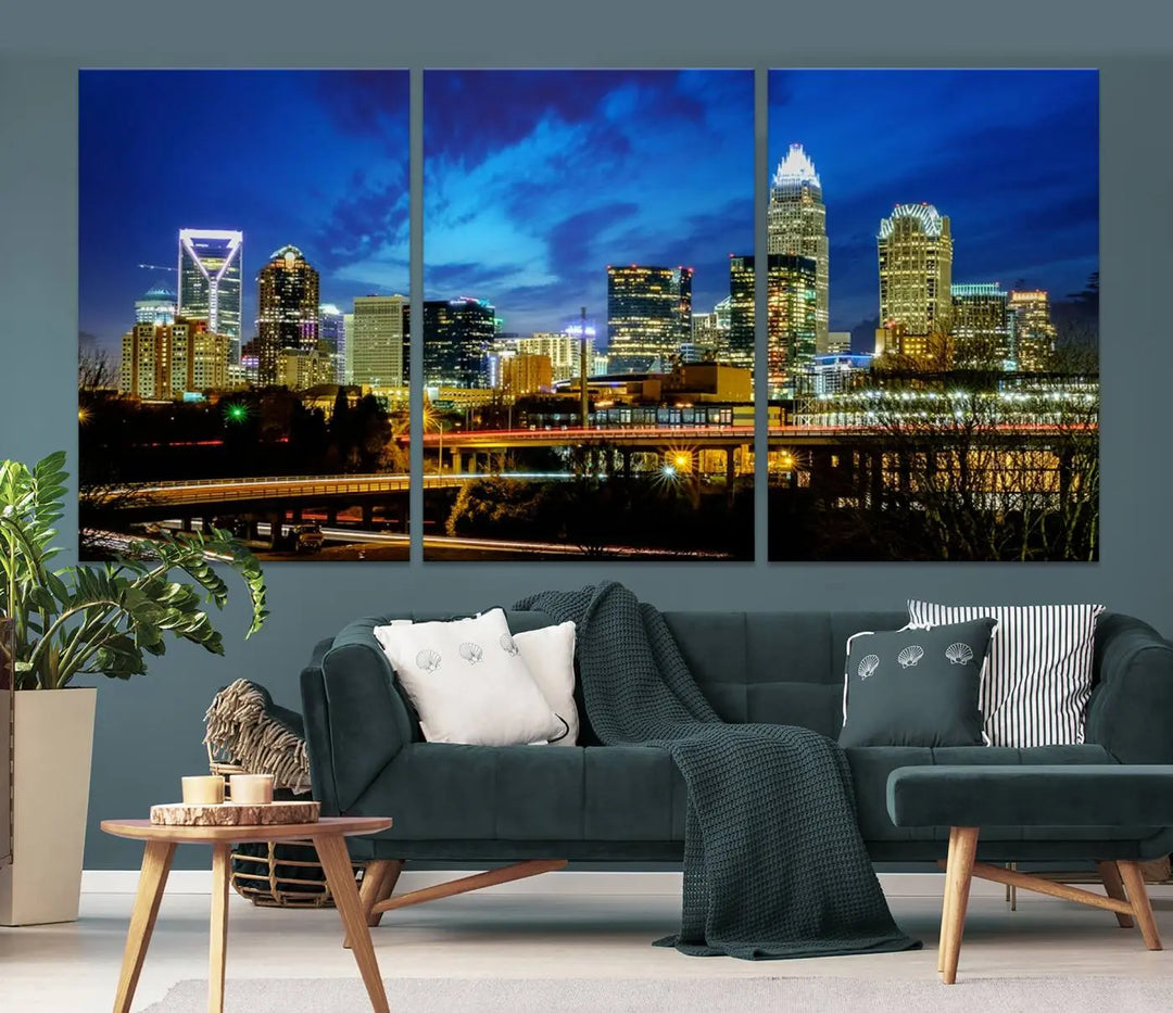 A modern living room highlighted by the "Charlotte City Lights Cloudy Blue Night Skyline Cityscape View" wall art canvas print, crafted on museum-quality canvas with UV-protective coating.