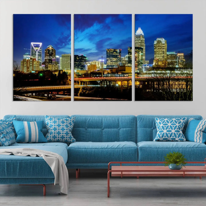 A modern living room highlighted by the "Charlotte City Lights Cloudy Blue Night Skyline Cityscape View" wall art canvas print, crafted on museum-quality canvas with UV-protective coating.