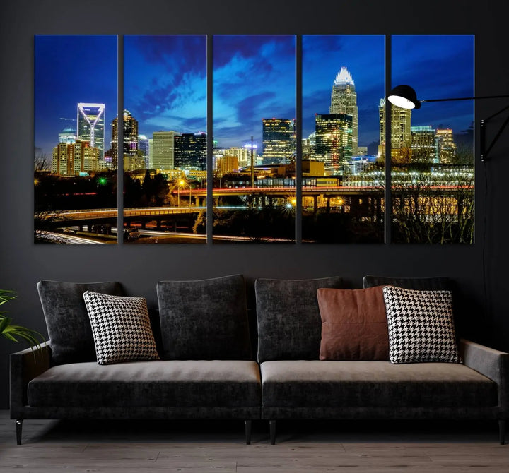 A modern living room highlighted by the "Charlotte City Lights Cloudy Blue Night Skyline Cityscape View" wall art canvas print, crafted on museum-quality canvas with UV-protective coating.