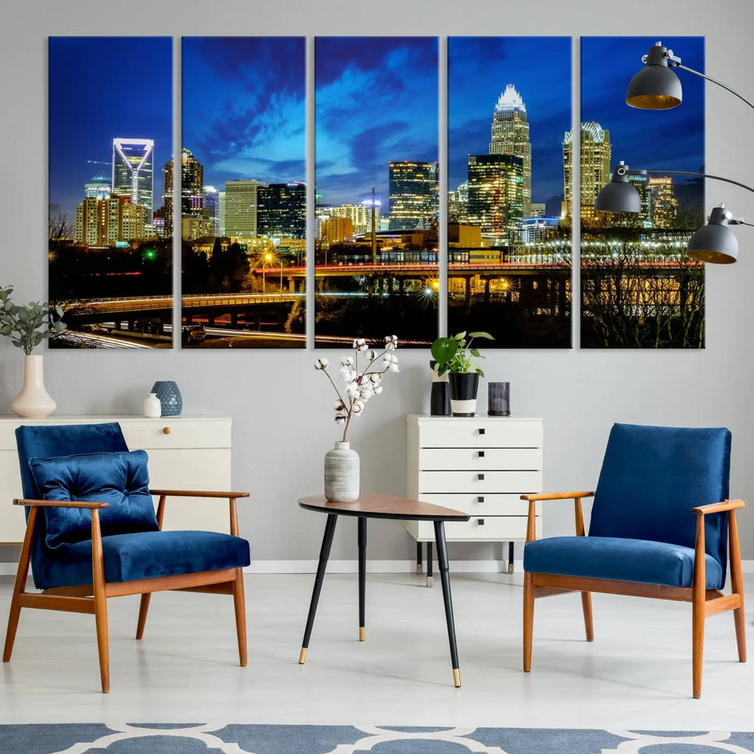 A modern living room highlighted by the "Charlotte City Lights Cloudy Blue Night Skyline Cityscape View" wall art canvas print, crafted on museum-quality canvas with UV-protective coating.