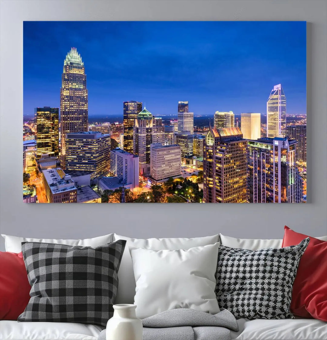 The living room features the "Charlotte City Lights Night Blue Skyline Cityscape View Wall Art Canvas Print" on museum-quality canvas with a UV-protective coating. Cozy and modern decor complements the ready-to-hang look.