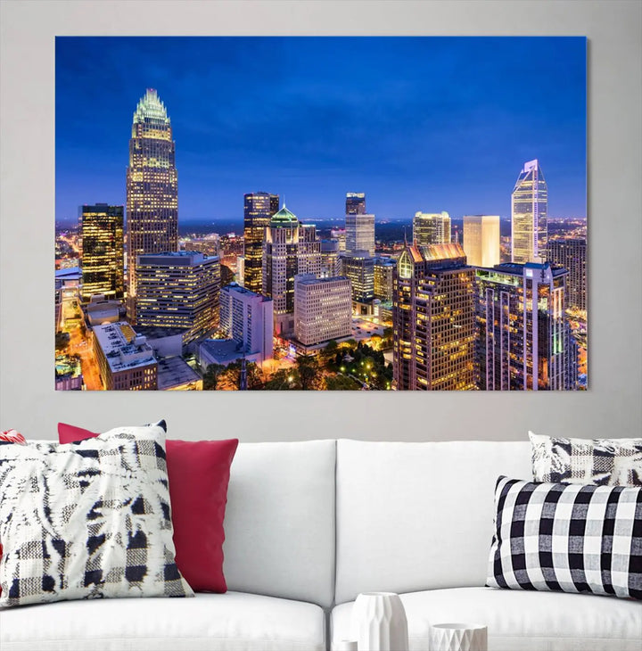 The living room features the "Charlotte City Lights Night Blue Skyline Cityscape View Wall Art Canvas Print" on museum-quality canvas with a UV-protective coating. Cozy and modern decor complements the ready-to-hang look.