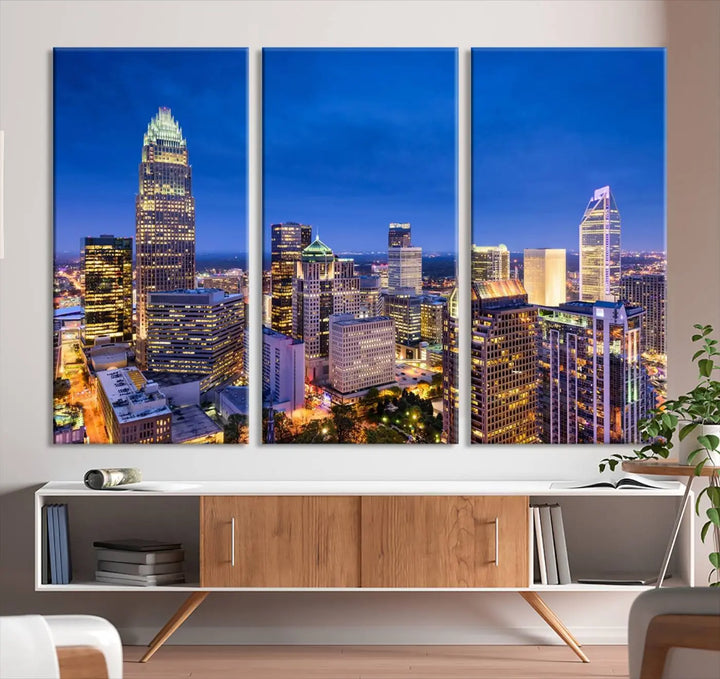 The living room features the "Charlotte City Lights Night Blue Skyline Cityscape View Wall Art Canvas Print" on museum-quality canvas with a UV-protective coating. Cozy and modern decor complements the ready-to-hang look.