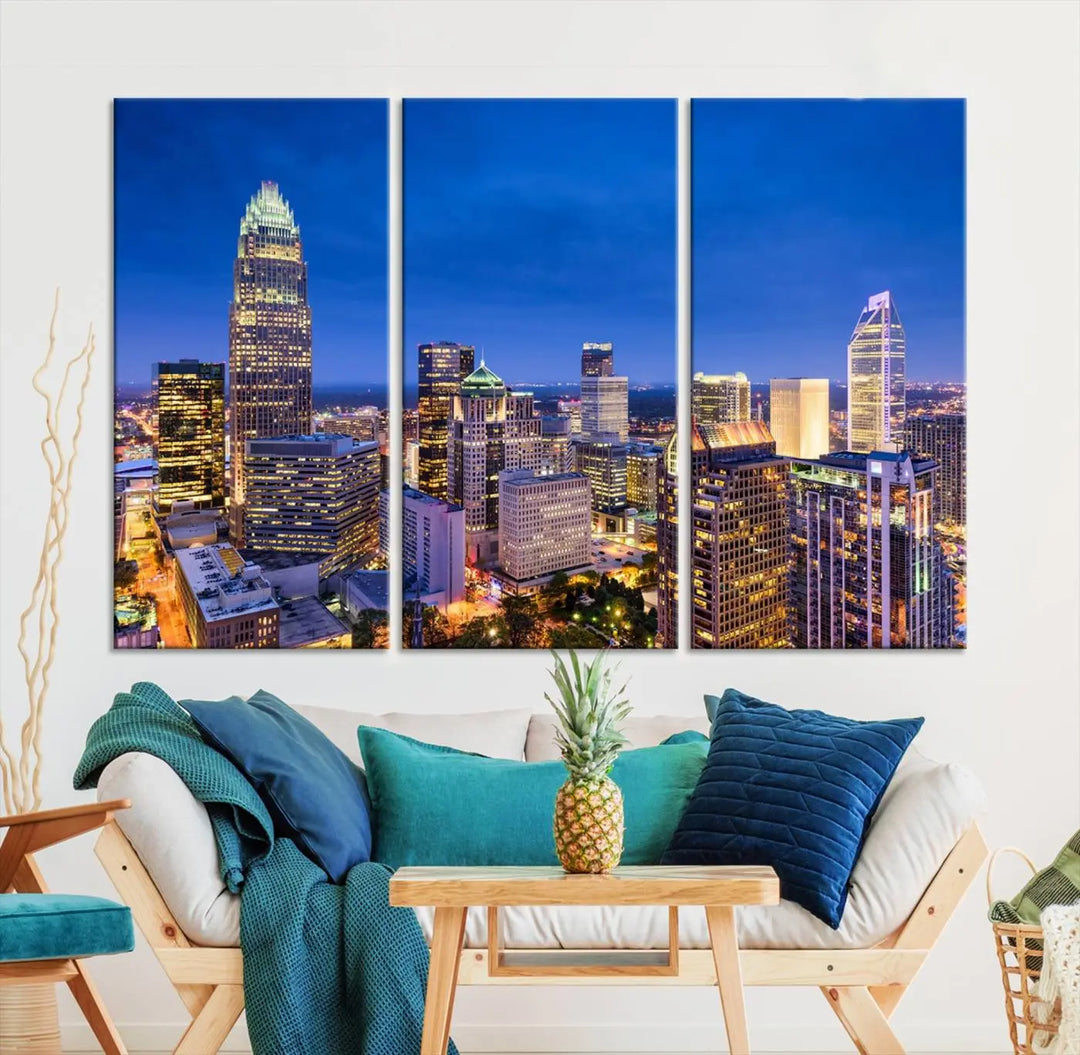 The living room features the "Charlotte City Lights Night Blue Skyline Cityscape View Wall Art Canvas Print" on museum-quality canvas with a UV-protective coating. Cozy and modern decor complements the ready-to-hang look.