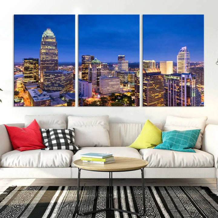 The living room features the "Charlotte City Lights Night Blue Skyline Cityscape View Wall Art Canvas Print" on museum-quality canvas with a UV-protective coating. Cozy and modern decor complements the ready-to-hang look.