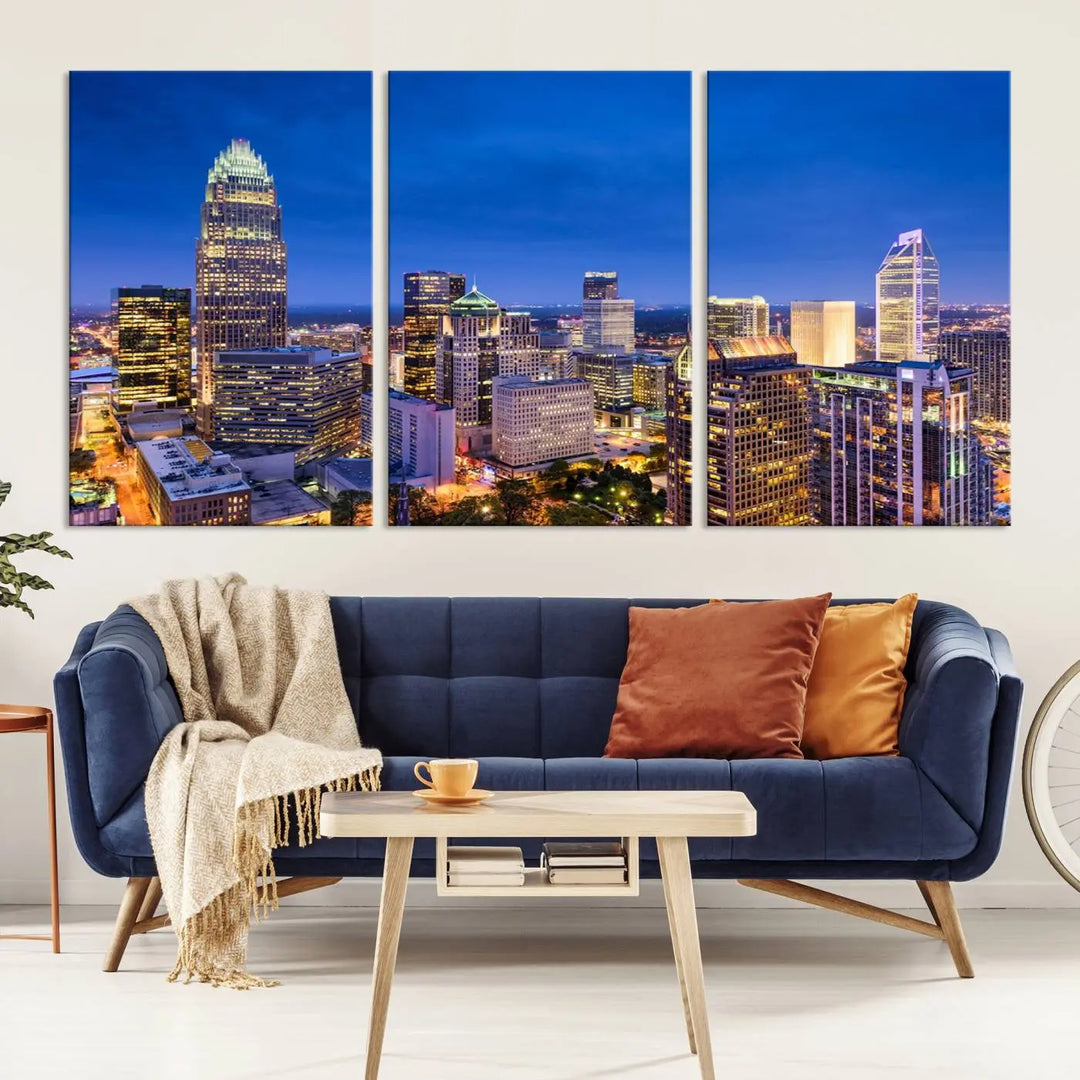 The living room features the "Charlotte City Lights Night Blue Skyline Cityscape View Wall Art Canvas Print" on museum-quality canvas with a UV-protective coating. Cozy and modern decor complements the ready-to-hang look.