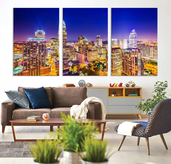 A modern living room features the Charlotte City Lights Night Blue Skyline Cityscape View wall art canvas print.