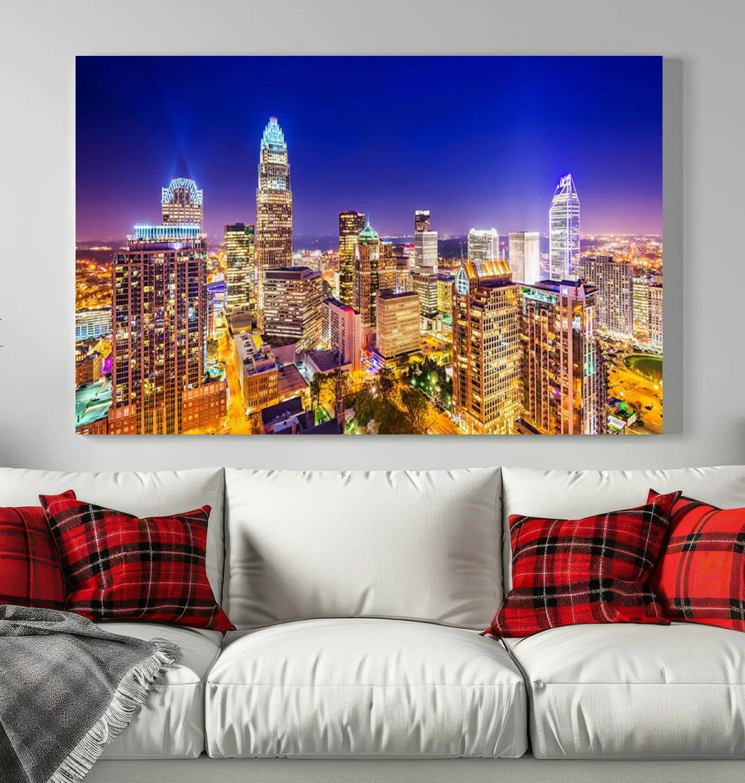 A modern living room features the Charlotte City Lights Night Blue Skyline Cityscape View wall art canvas print.