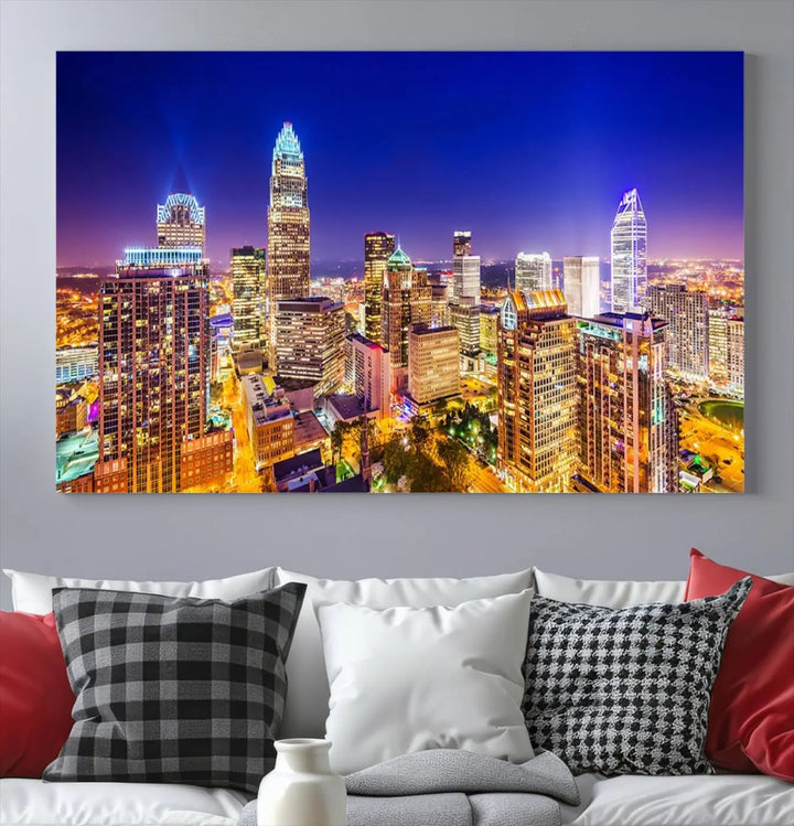 A modern living room features the Charlotte City Lights Night Blue Skyline Cityscape View wall art canvas print.