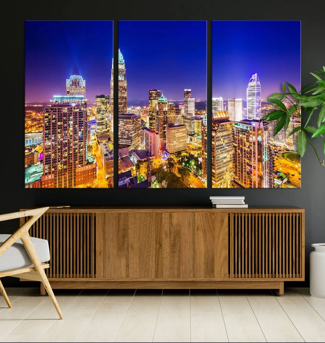 A modern living room features the Charlotte City Lights Night Blue Skyline Cityscape View wall art canvas print.