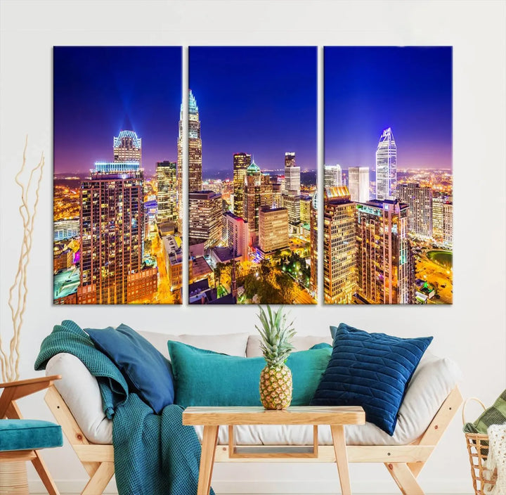 A modern living room features the Charlotte City Lights Night Blue Skyline Cityscape View wall art canvas print.