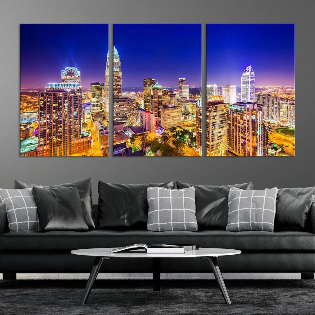 A modern living room features the Charlotte City Lights Night Blue Skyline Cityscape View wall art canvas print.