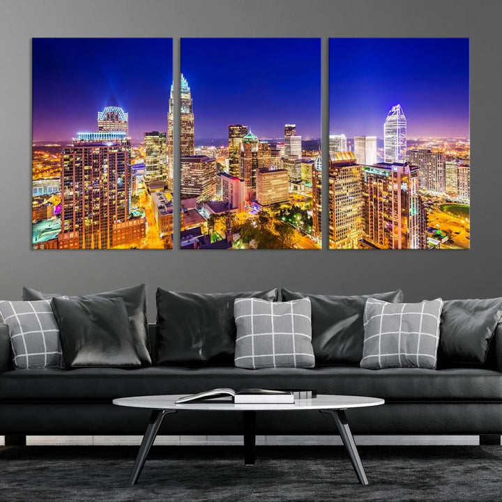 A modern living room features the Charlotte City Lights Night Blue Skyline Cityscape View wall art canvas print.