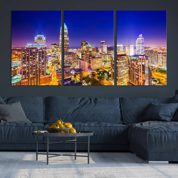 A modern living room features the Charlotte City Lights Night Blue Skyline Cityscape View wall art canvas print.