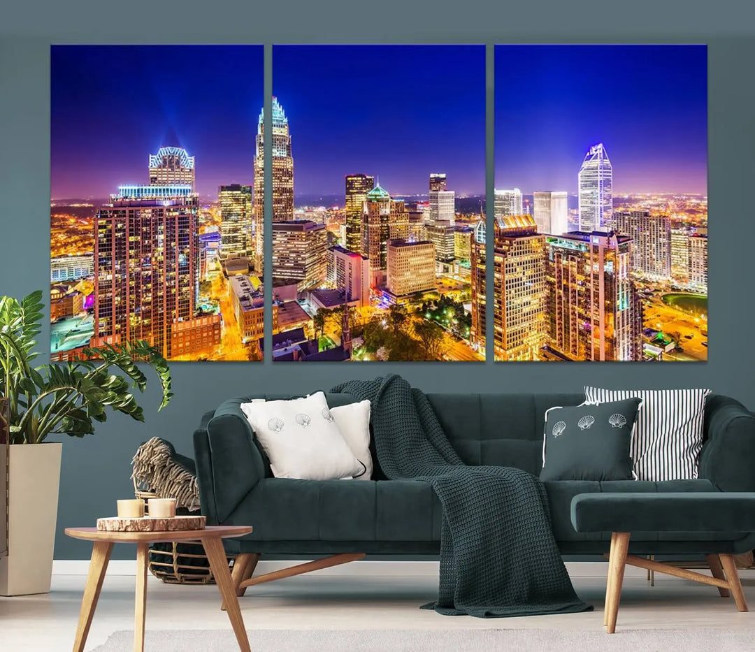 A modern living room features the Charlotte City Lights Night Blue Skyline Cityscape View wall art canvas print.