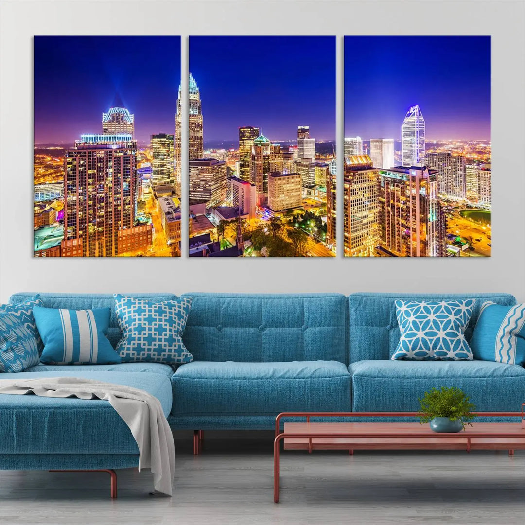 A modern living room features the Charlotte City Lights Night Blue Skyline Cityscape View wall art canvas print.