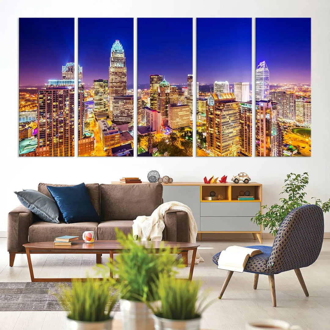 A modern living room features the Charlotte City Lights Night Blue Skyline Cityscape View wall art canvas print.