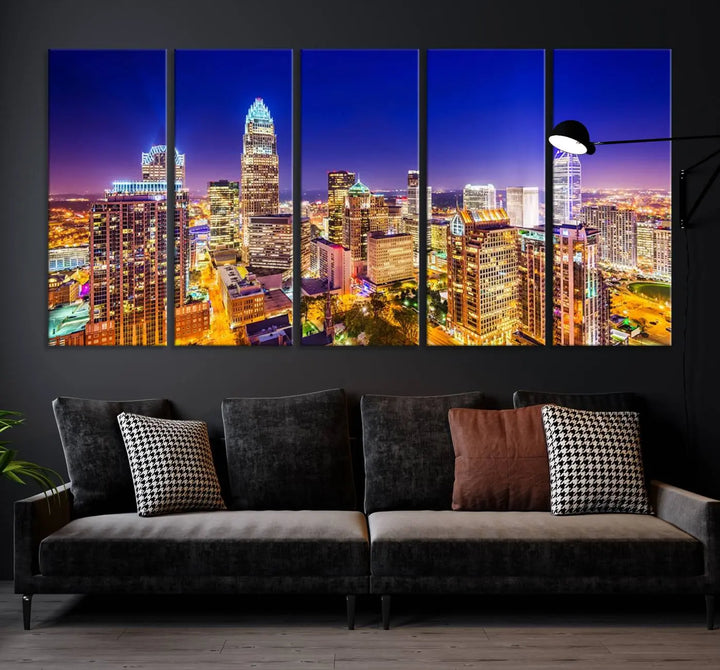 A modern living room features the Charlotte City Lights Night Blue Skyline Cityscape View wall art canvas print.