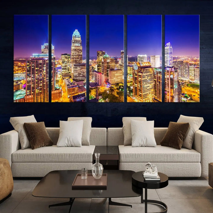 A modern living room features the Charlotte City Lights Night Blue Skyline Cityscape View wall art canvas print.