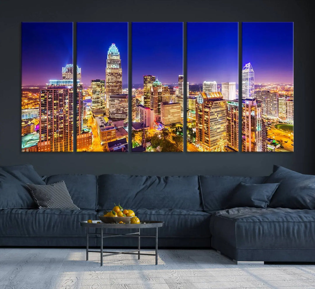 A modern living room features the Charlotte City Lights Night Blue Skyline Cityscape View wall art canvas print.