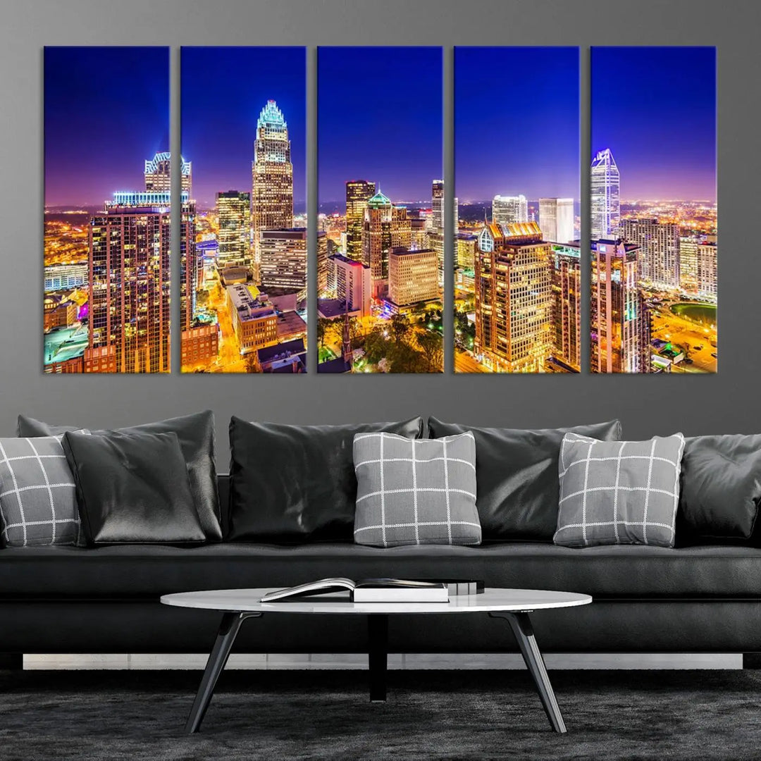 A modern living room features the Charlotte City Lights Night Blue Skyline Cityscape View wall art canvas print.