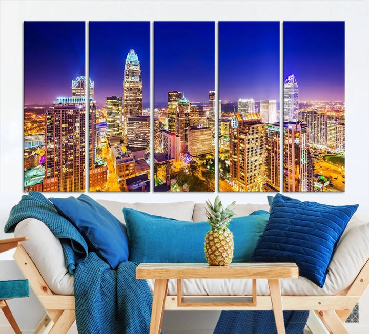 A modern living room features the Charlotte City Lights Night Blue Skyline Cityscape View wall art canvas print.