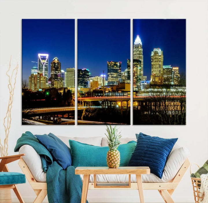 The Charlotte City Lights Night Blue Skyline Cityscape View Wall Art Canvas Print, showcasing an illuminated city skyline at night, is printed on museum-quality canvas with a UV-protective coating. Enhance your space with this stunning piece and enjoy free shipping with your purchase.