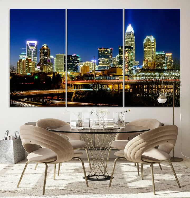 The Charlotte City Lights Night Blue Skyline Cityscape View Wall Art Canvas Print, showcasing an illuminated city skyline at night, is printed on museum-quality canvas with a UV-protective coating. Enhance your space with this stunning piece and enjoy free shipping with your purchase.