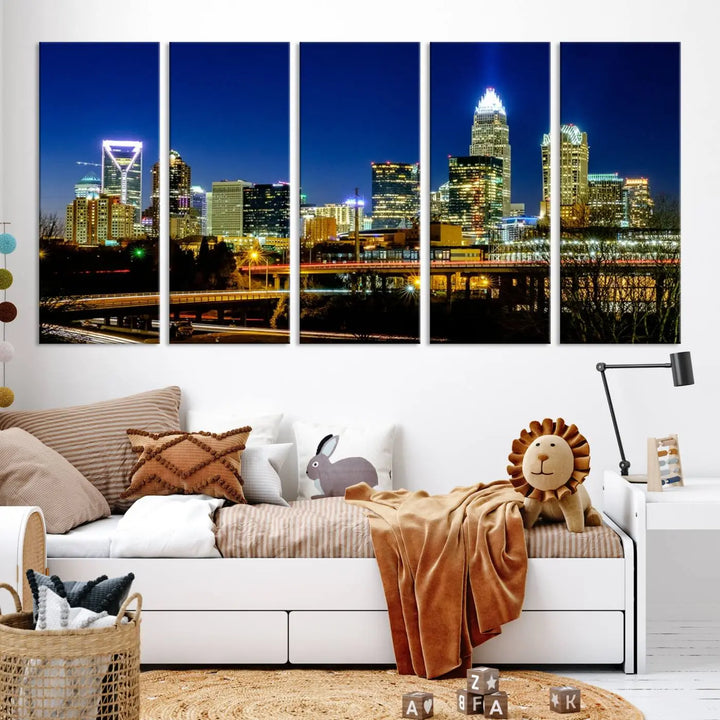 The Charlotte City Lights Night Blue Skyline Cityscape View Wall Art Canvas Print, showcasing an illuminated city skyline at night, is printed on museum-quality canvas with a UV-protective coating. Enhance your space with this stunning piece and enjoy free shipping with your purchase.