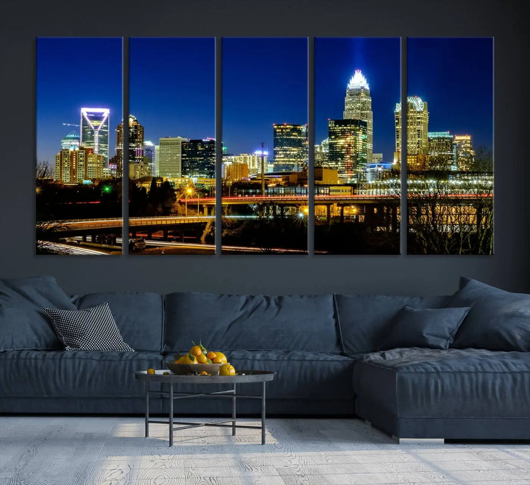 The Charlotte City Lights Night Blue Skyline Cityscape View Wall Art Canvas Print, showcasing an illuminated city skyline at night, is printed on museum-quality canvas with a UV-protective coating. Enhance your space with this stunning piece and enjoy free shipping with your purchase.