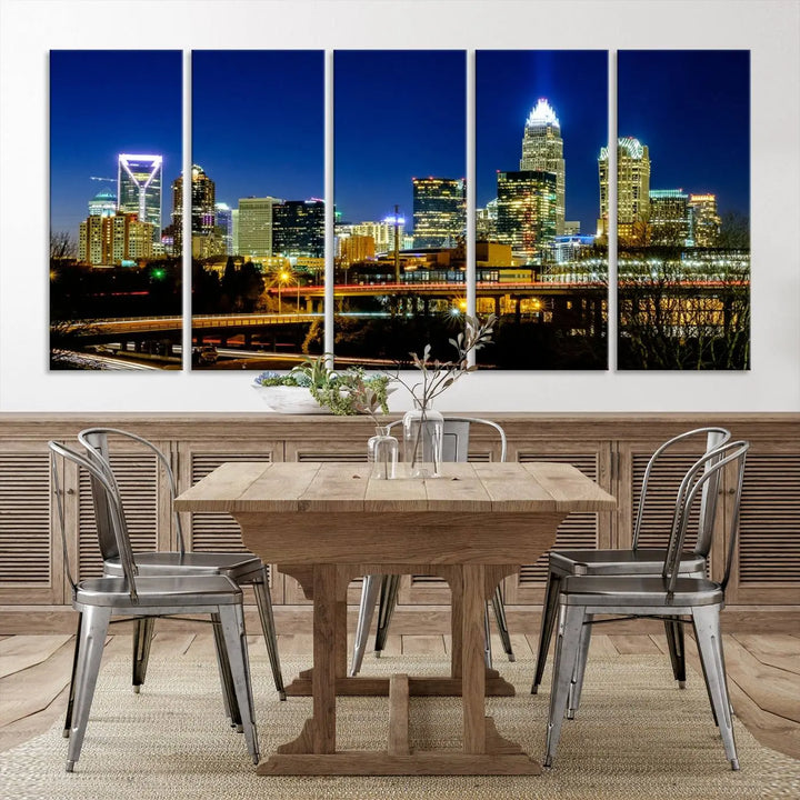 The Charlotte City Lights Night Blue Skyline Cityscape View Wall Art Canvas Print, showcasing an illuminated city skyline at night, is printed on museum-quality canvas with a UV-protective coating. Enhance your space with this stunning piece and enjoy free shipping with your purchase.