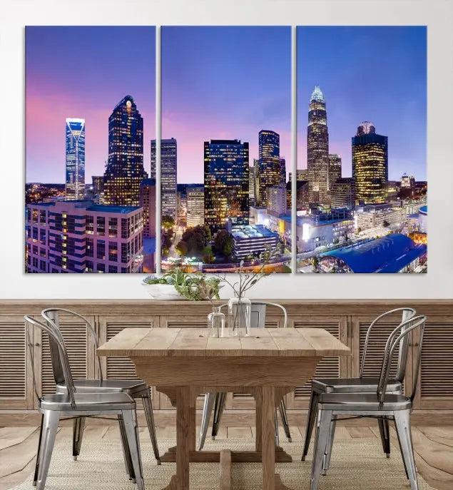 The Charlotte City Lights Sunset Purple Skyline Cityscape View Wall Art Canvas Print showcases a triptych of a city skyline with illuminated skyscrapers at dusk.