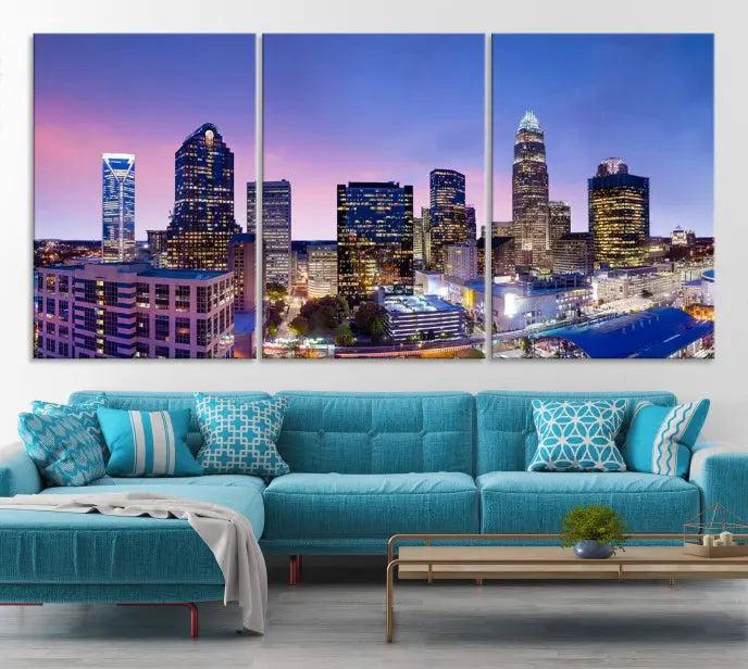 The Charlotte City Lights Sunset Purple Skyline Cityscape View Wall Art Canvas Print showcases a triptych of a city skyline with illuminated skyscrapers at dusk.