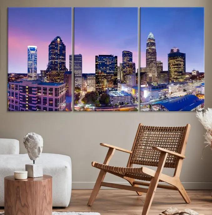 The Charlotte City Lights Sunset Purple Skyline Cityscape View Wall Art Canvas Print showcases a triptych of a city skyline with illuminated skyscrapers at dusk.