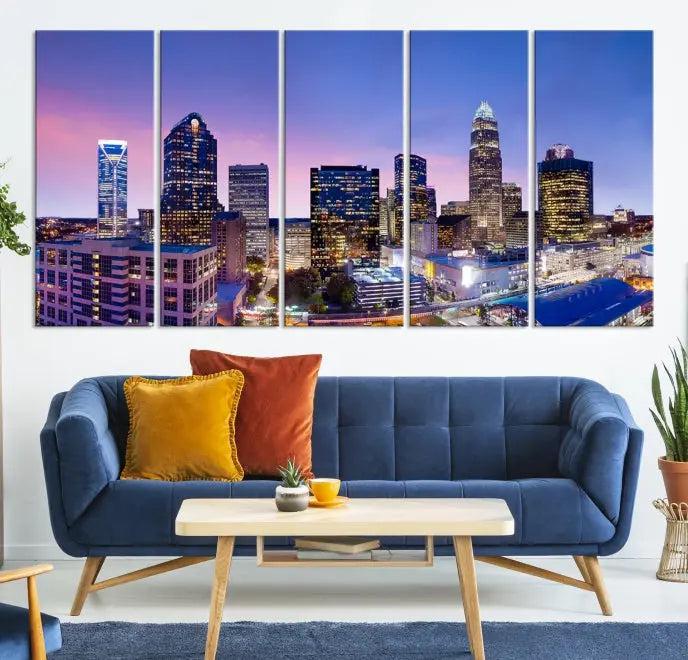 The Charlotte City Lights Sunset Purple Skyline Cityscape View Wall Art Canvas Print showcases a triptych of a city skyline with illuminated skyscrapers at dusk.