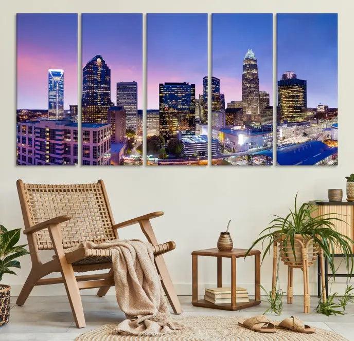 The Charlotte City Lights Sunset Purple Skyline Cityscape View Wall Art Canvas Print showcases a triptych of a city skyline with illuminated skyscrapers at dusk.