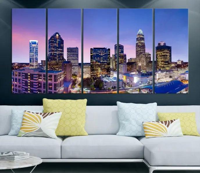 The Charlotte City Lights Sunset Purple Skyline Cityscape View Wall Art Canvas Print showcases a triptych of a city skyline with illuminated skyscrapers at dusk.