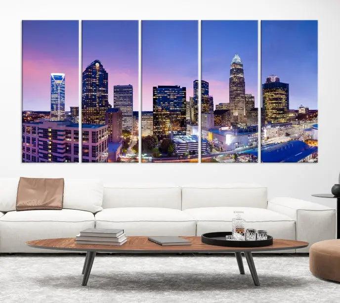 The Charlotte City Lights Sunset Purple Skyline Cityscape View Wall Art Canvas Print showcases a triptych of a city skyline with illuminated skyscrapers at dusk.