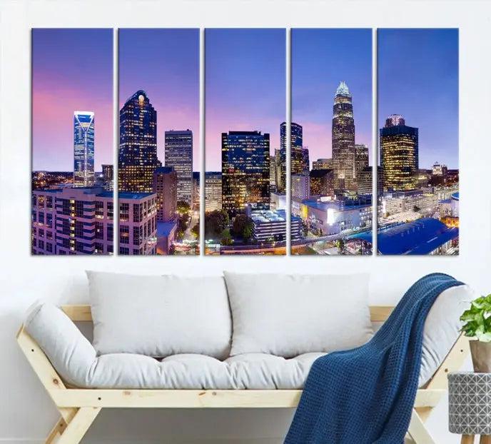 The Charlotte City Lights Sunset Purple Skyline Cityscape View Wall Art Canvas Print showcases a triptych of a city skyline with illuminated skyscrapers at dusk.