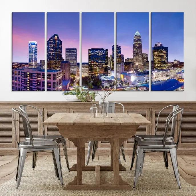 The Charlotte City Lights Sunset Purple Skyline Cityscape View Wall Art Canvas Print showcases a triptych of a city skyline with illuminated skyscrapers at dusk.