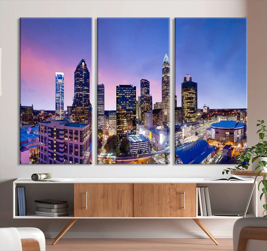 The living room features the "Charlotte City Lights Sunset Purple Skyline Cityscape View Wall Art Canvas Print," a mesmerizing depiction of a city skyline at sunset split into five panels on museum-quality canvas. This gallery-wrapped artwork is enhanced with a UV-protective coating, ensuring that its captivating colors stay vibrant for years.