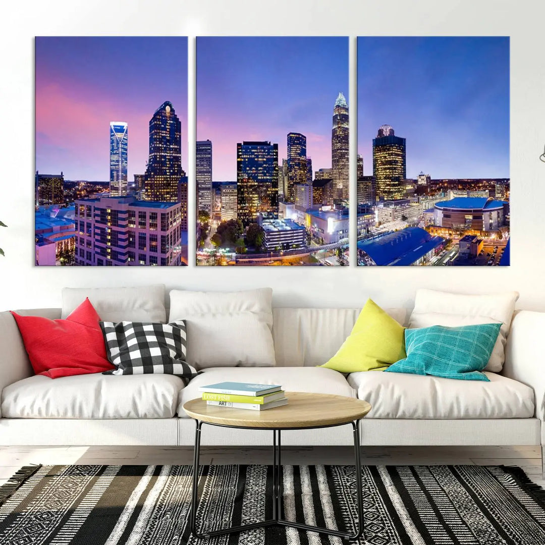 The living room features the "Charlotte City Lights Sunset Purple Skyline Cityscape View Wall Art Canvas Print," a mesmerizing depiction of a city skyline at sunset split into five panels on museum-quality canvas. This gallery-wrapped artwork is enhanced with a UV-protective coating, ensuring that its captivating colors stay vibrant for years.