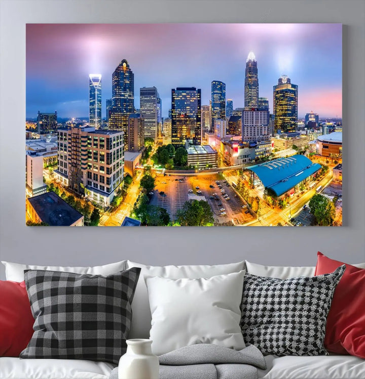 The "Charlotte City Lights Sunset Purple Skyline Cityscape View Wall Art Canvas Print" features a triptych of a vibrant city skyline at dusk, highlighting illuminated skyscrapers and urban streets. This artwork is crafted on museum-quality polycotton canvas, with its gallery-wrapped design ensuring durability and visual appeal for years to come.