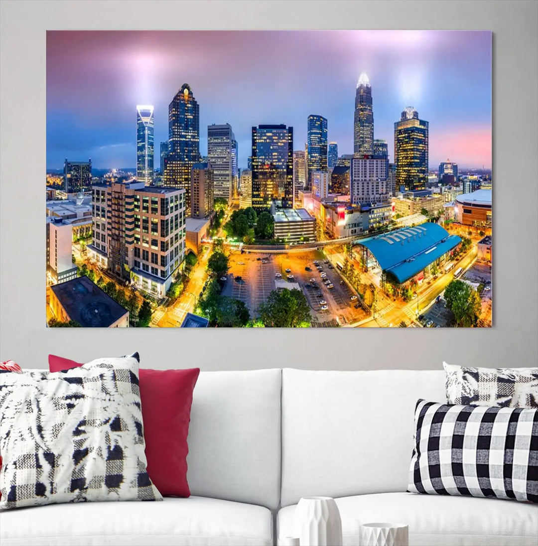 The "Charlotte City Lights Sunset Purple Skyline Cityscape View Wall Art Canvas Print" features a triptych of a vibrant city skyline at dusk, highlighting illuminated skyscrapers and urban streets. This artwork is crafted on museum-quality polycotton canvas, with its gallery-wrapped design ensuring durability and visual appeal for years to come.