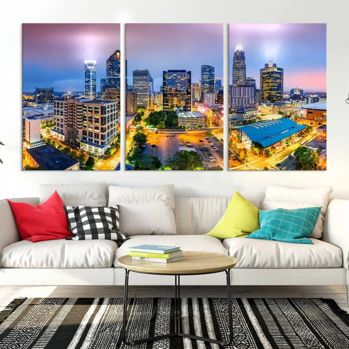 The "Charlotte City Lights Sunset Purple Skyline Cityscape View Wall Art Canvas Print" features a triptych of a vibrant city skyline at dusk, highlighting illuminated skyscrapers and urban streets. This artwork is crafted on museum-quality polycotton canvas, with its gallery-wrapped design ensuring durability and visual appeal for years to come.