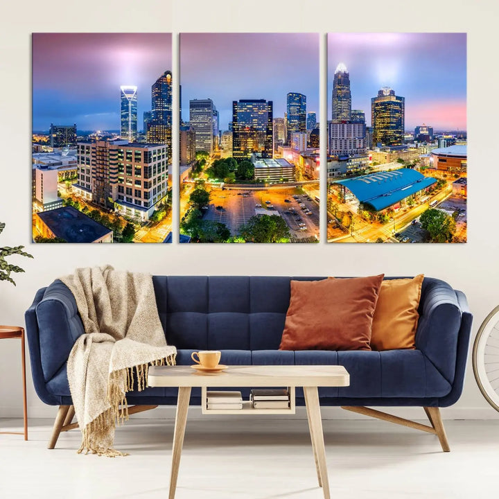 The "Charlotte City Lights Sunset Purple Skyline Cityscape View Wall Art Canvas Print" features a triptych of a vibrant city skyline at dusk, highlighting illuminated skyscrapers and urban streets. This artwork is crafted on museum-quality polycotton canvas, with its gallery-wrapped design ensuring durability and visual appeal for years to come.